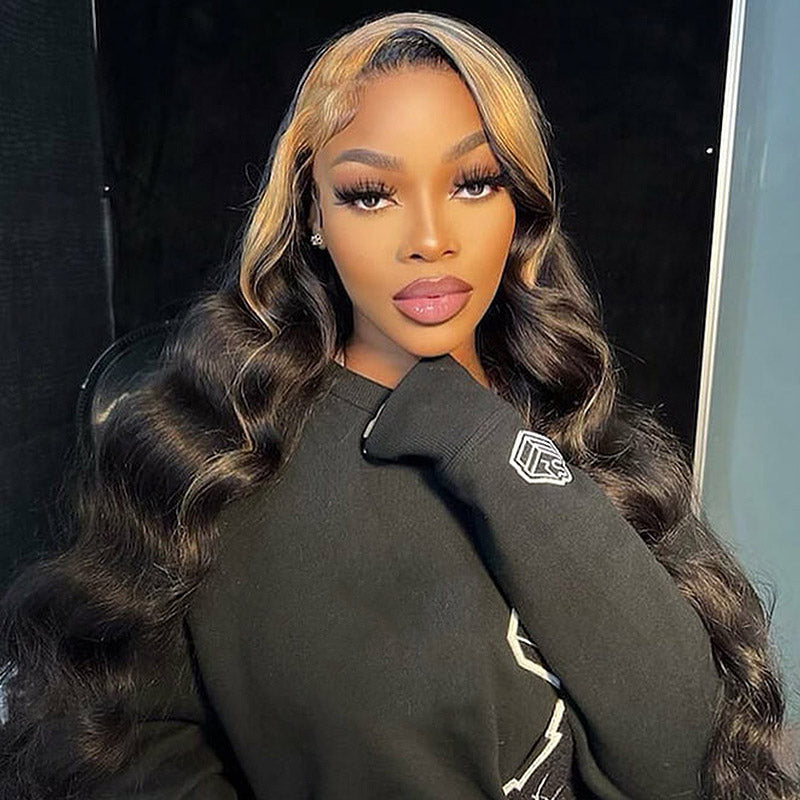 Model With Long, Wavy Black and Blonde-Highlighted Hair in a Black Sweatshirt