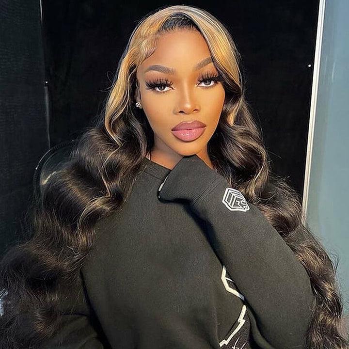 Model With Long, Wavy Black and Blonde-Highlighted Hair in a Black Sweatshirt