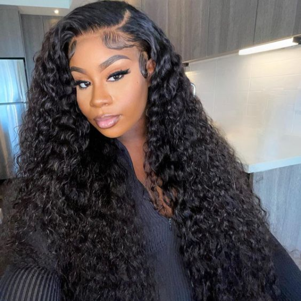 Woman wearing Ishow Beauty's long, curly water wave wig in natural black and bright pink jacket, showcasing pre-plucked hairline.