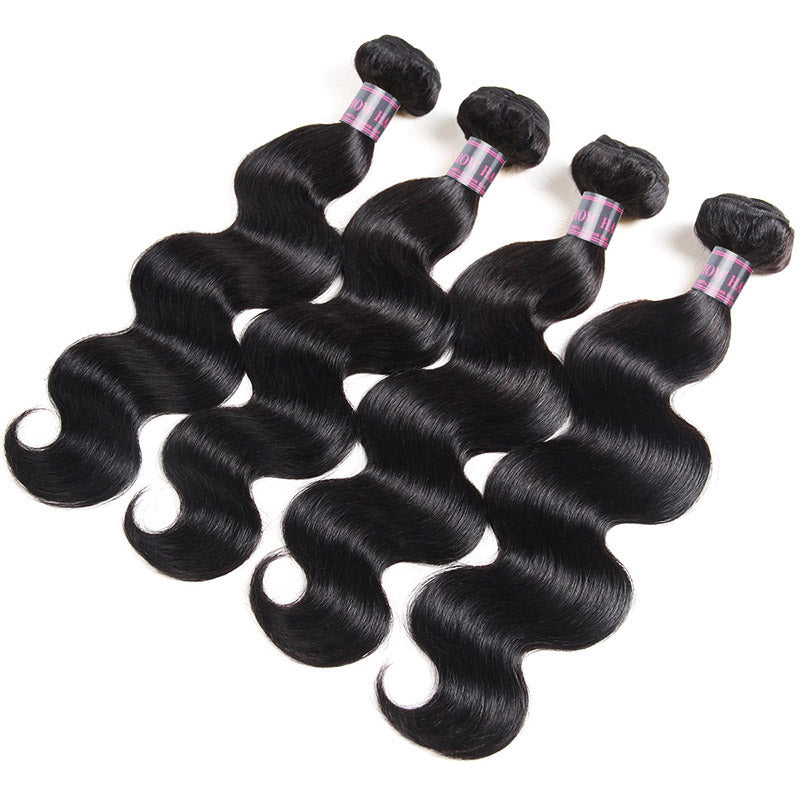 Four Bundles of Wavy Jet Black Human Hair Extensions Arranged in a Row