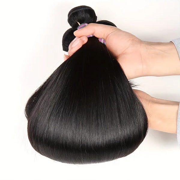 Hand Holding Straight Brazilian Hair Bundle With Shiny, Natural Black Color