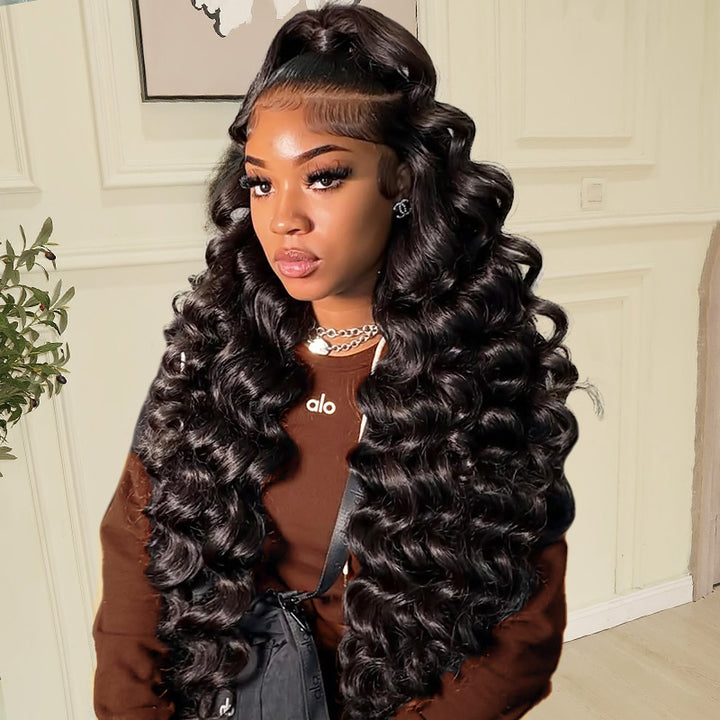 Woman with long loose deep wave 7x6 wig wearing a brown jacket indoors.