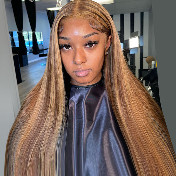 Woman wearing a long highlight brown straight hair wig with P4/27 color and pre-plucked hairline, styled edges, and middle part, in a cozy room with art on the walls.