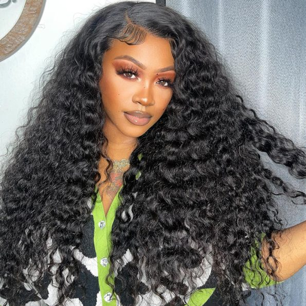 Model Flaunting Voluminous Loose Deep Wave Human Hair Wig With Defined Curls