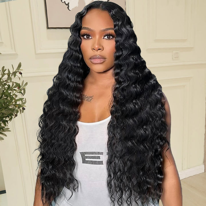 Woman with natural black deep wave lace closure hair wearing a white tank top indoors.