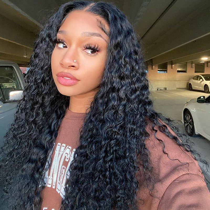 Model Displaying Long Water Wave Wig in Natural Black, Styled in Urban Setting