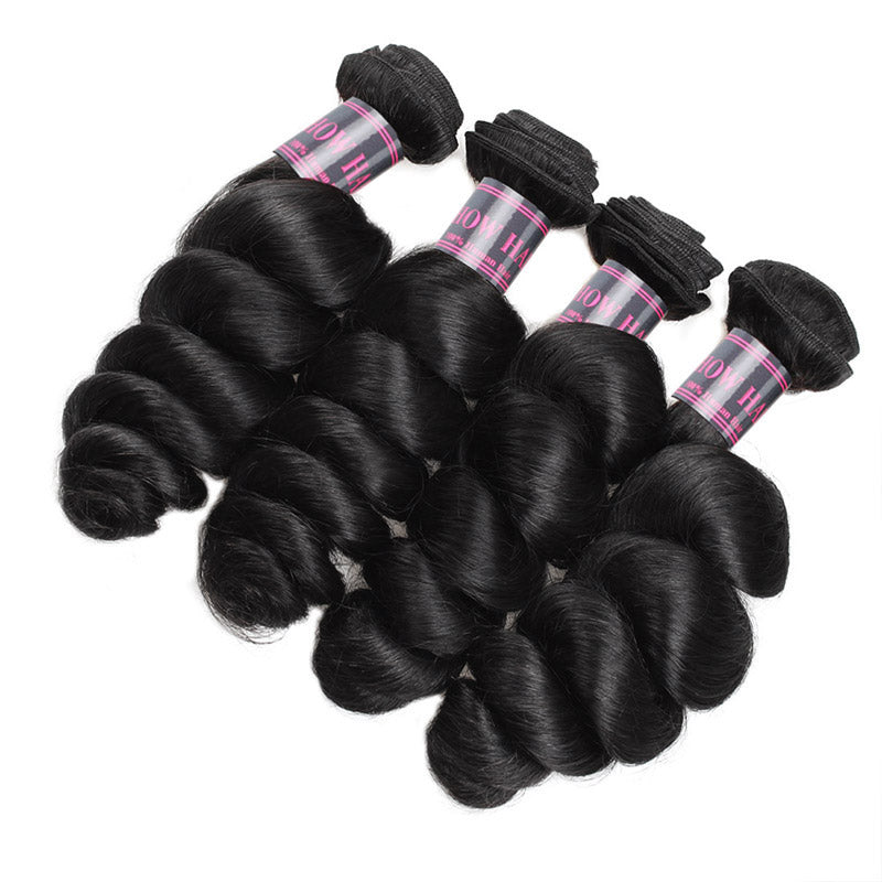 Four Bundles of Luxurious Wavy Jet Black Human Hair Extensions Displayed Together