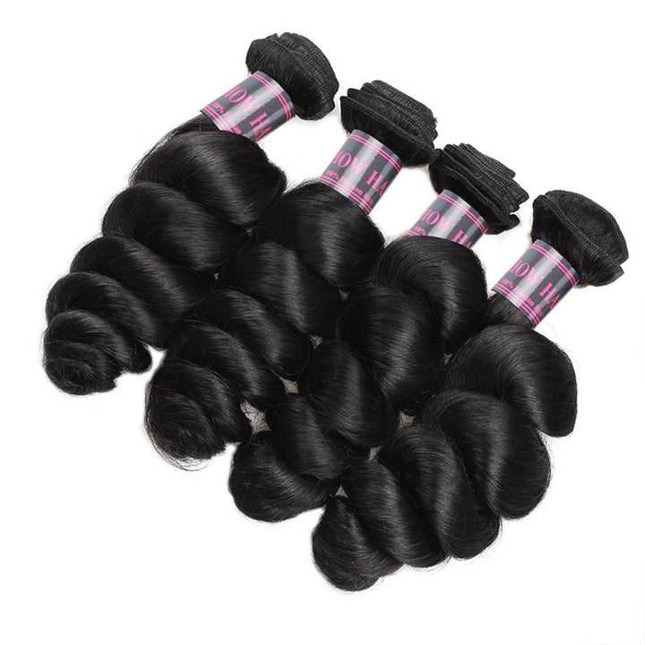 Four Bundles of Luxurious Wavy Jet Black Human Hair Extensions Displayed Together
