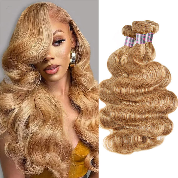 Woman with luxurious long honey blonde body wave hair wearing a grey top, showcasing vibrant 27# blonde color and natural shine.