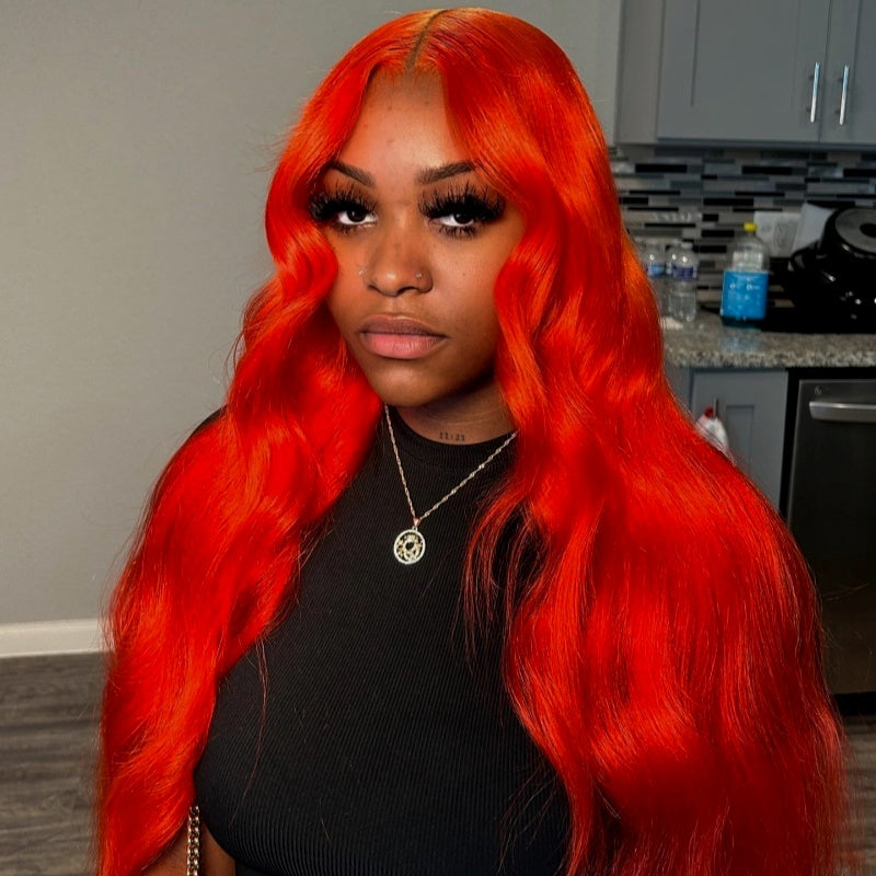 Model With Vibrant Orange Body Wave Wig Showcasing Seamless Style and Shine