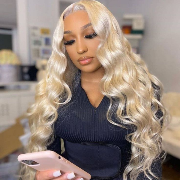 Woman With Blonde Body Wave Wig Checking Phone in a Stylish Outfit