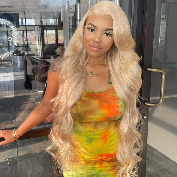Model Showcasing 613 Blonde Body Wave Wig in a Colorful Dress