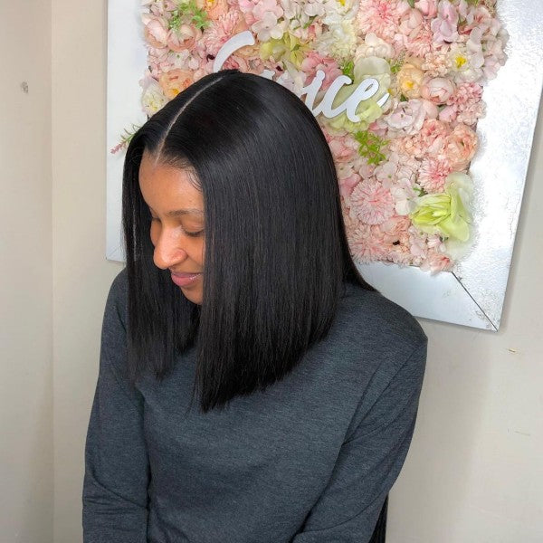 Model With Straight Bob Hairstyle Showing a Natural Hairline in Front of Flower Decor