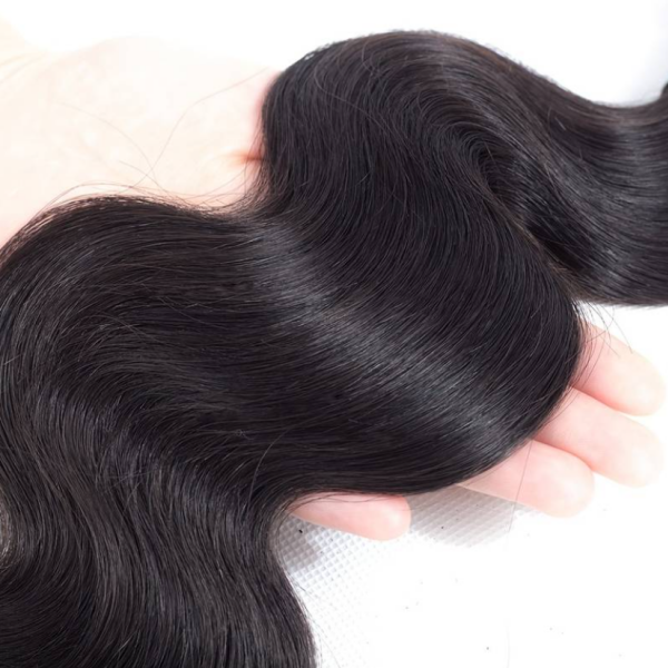 Natural Black Body Wave Hair Extension Held in Hand Showcasing Its Soft, Wavy Texture
