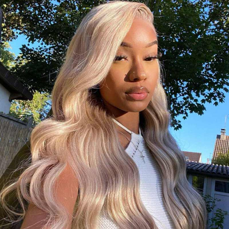 Blonde Wavy Wig On a Woman Outdoors in a Stylish White Outfit