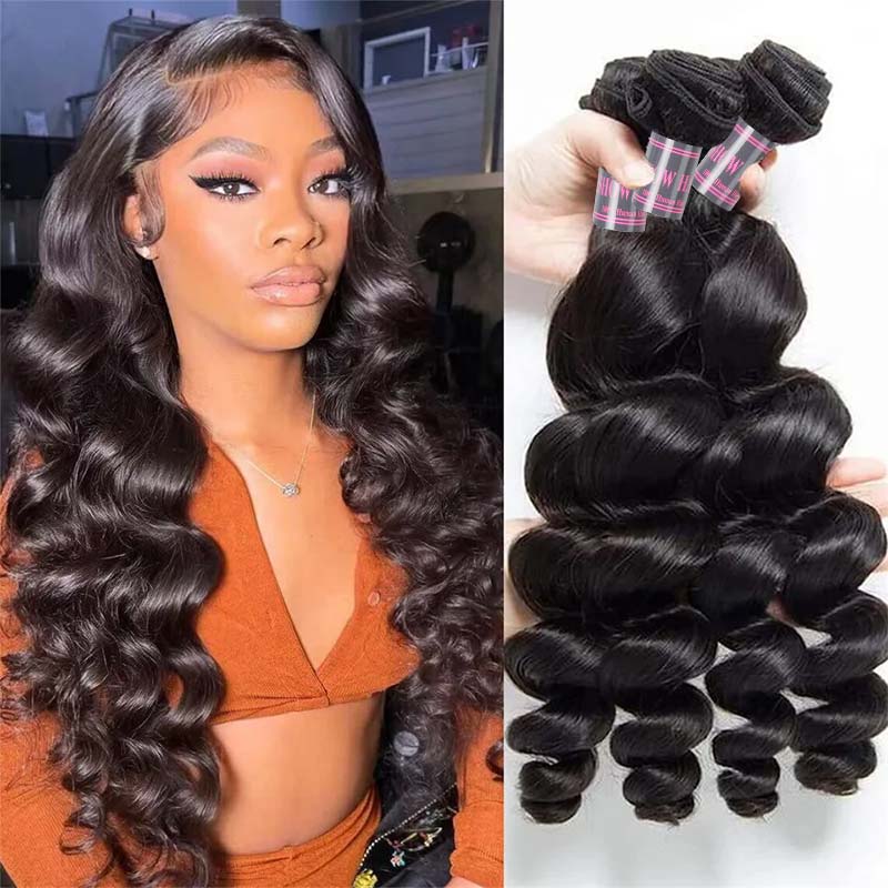 Hand holding four bundles of Ishow Brazilian loose wave hair extensions in natural black color