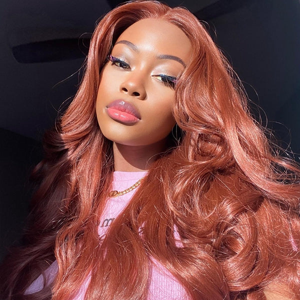 Woman With Long Brick Pink Wavy Hair and Makeup, Wearing a Pink Top