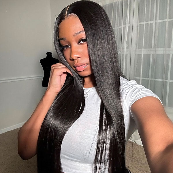 Woman seated in a car, wearing a long, straight, natural black human hair wig from Ishow Beauty, featuring a middle parting and a sleek finish.