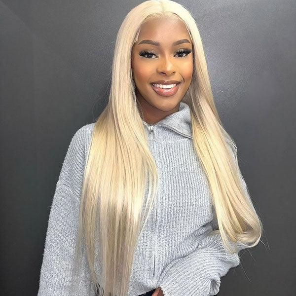 Long Straight 613 Blonde Wig On a Smiling Woman Wearing a Gray Sweater