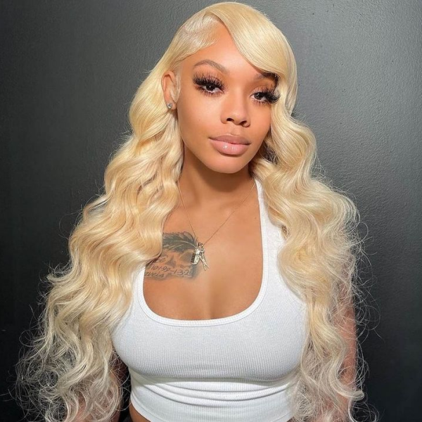 Model Displaying 613 Blonde Body Wave Wig With Natural Hairline and Glossy Finish