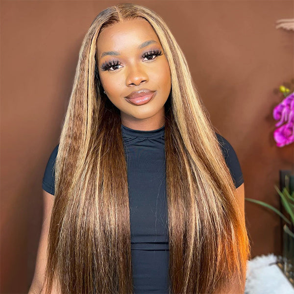 Highlighted honey blonde kinky straight wig with pre-cut lace closure, worn by a person in a white and black striped top, posing indoors