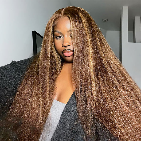 Woman with long straight P4/27 highlighted lace frontal wig, 100% human hair, wearing a black semi-sheer top, posing indoors.