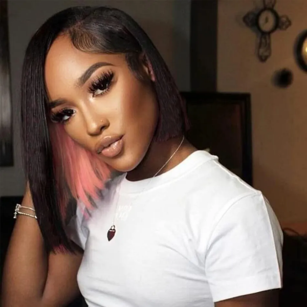 Woman Sporting a Peekaboo Pink Highlighted Straight Bob Wig in a Stylish Pose