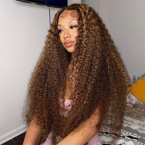 Person wearing Ishow Beauty’s PPB™ Invisible Knots Balayage Highlight Wig with 13x6 glueless lace front, kinky curly texture, and P4/27 color, standing indoors.