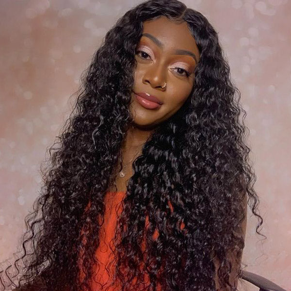 Woman with deep wave Malaysian hair styled in a side part, wearing a white shirt with black crescent patterns, showcasing 100% Virgin Remy Human Hair Extensions from Ishow Beauty.