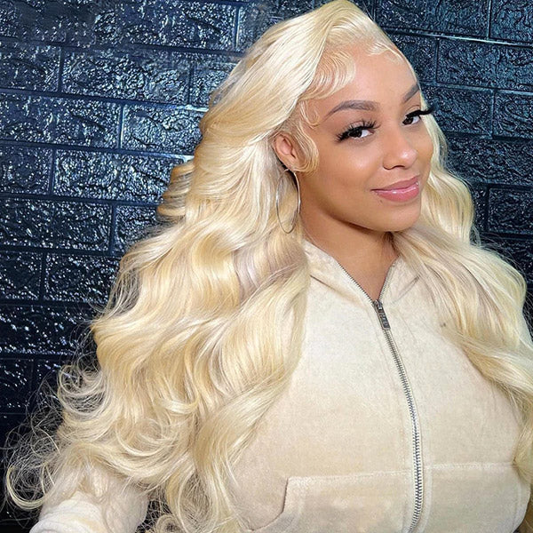 Model Smiling in Long, Wavy 613 Blonde Body Wave Wig With Natural Hairline