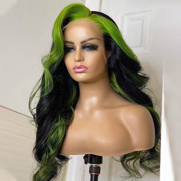 Woman wearing a Green Skunk Stripe Lace Front Wig, body wave texture in black and green, 30 inches long with baby hairline, dressed in black against a geometric background.