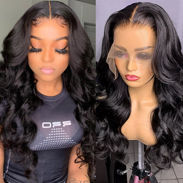 Woman wearing an Ishow Body Wave Lace Front Wig in natural black color, adjusting her hair with hand. The wig features a wavy texture and a pre-pluck natural hairline, displayed in a modern home setting.