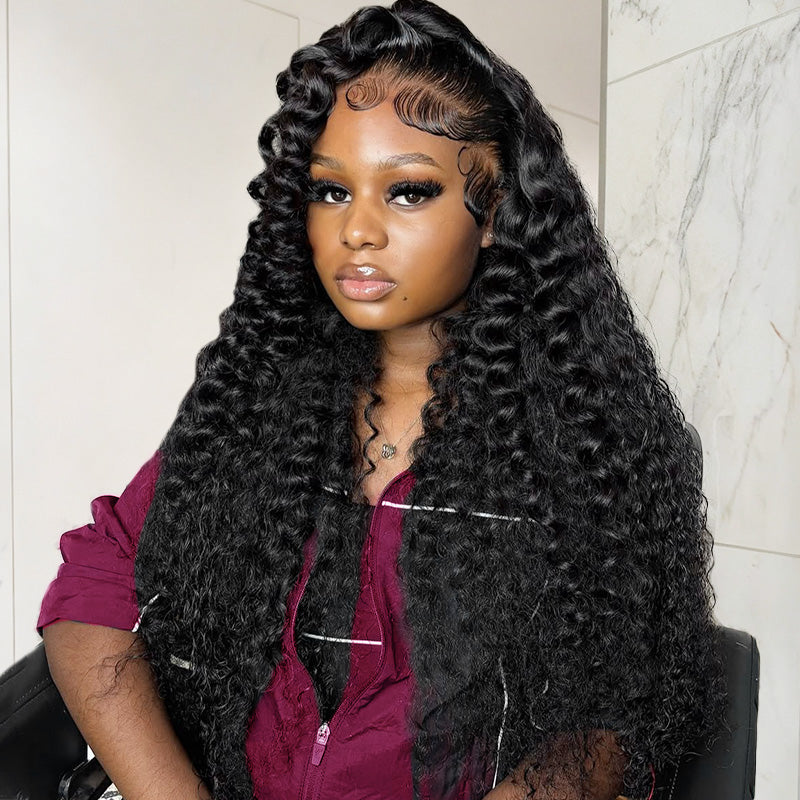 The Black woman with long & styled deep wave hair bundles wearing a purple top