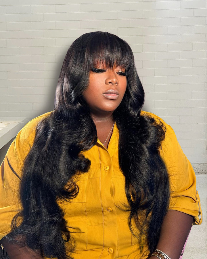 A Women Wear A Natural Black Color Body Wave Wig With Bangs, Shiny Look
